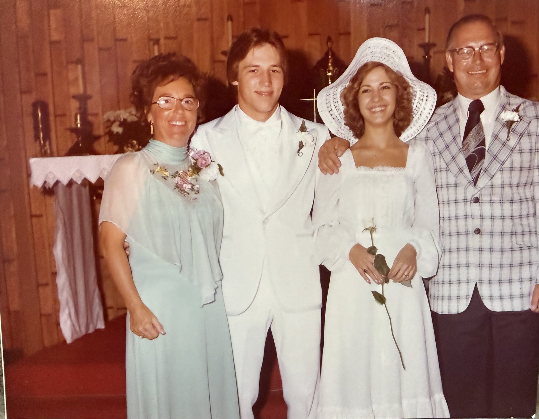 Linda and Rich with family at the altar